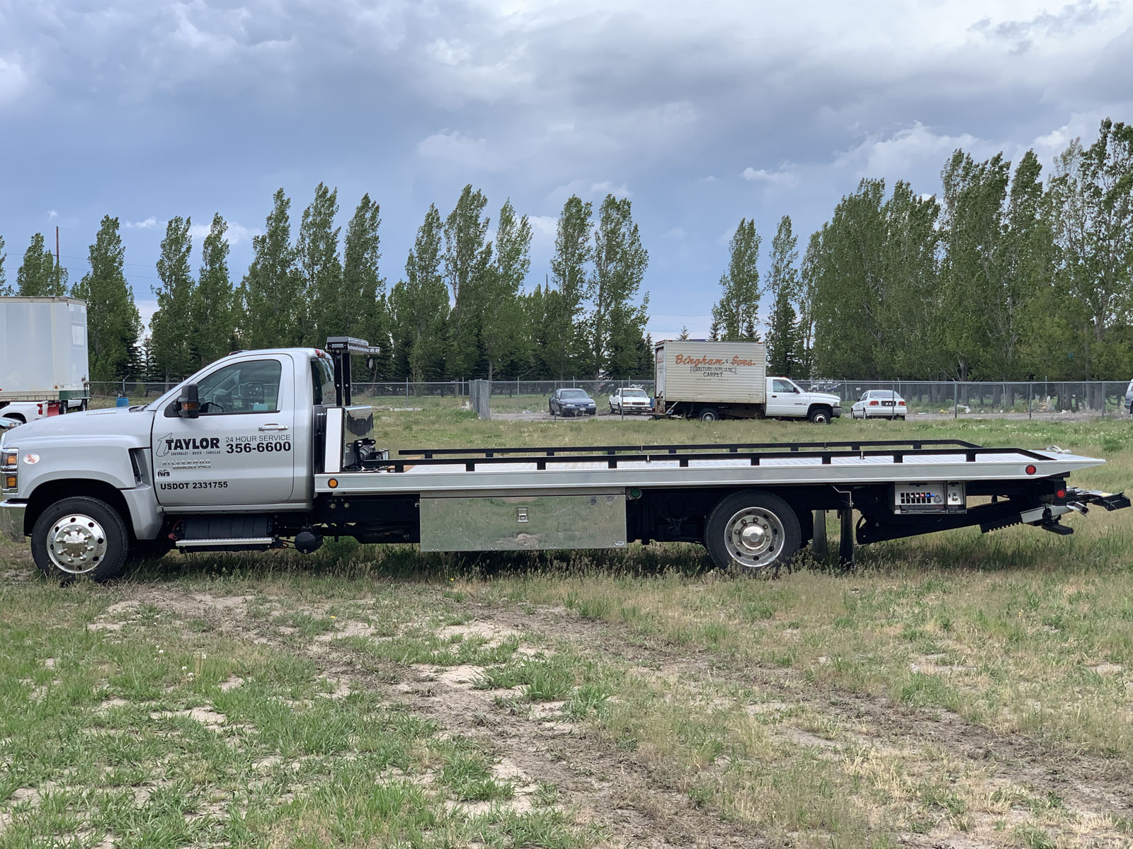 Taylor Chevrolet tow truck loading a vehicle
